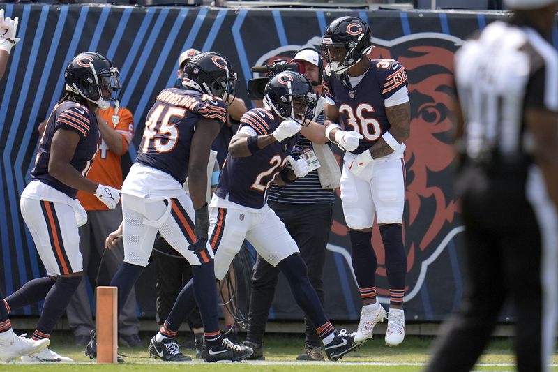 Chicago Bears' Jonathan Owens (36) celebrates with teammates after scoring on a blocked Tennessee Titans' punt during the second half of an NFL football game Sunday, Sept. 8, 2024, in Chicago. (AP Photo/Erin Hooley)