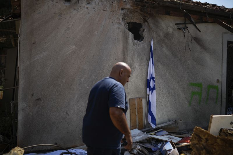 A man looks at a damaged house that was hit by a rocket fired from Lebanon, near Safed, northern Israel, on Wednesday, Sept. 25, 2024. (AP Photo//Leo Correa)