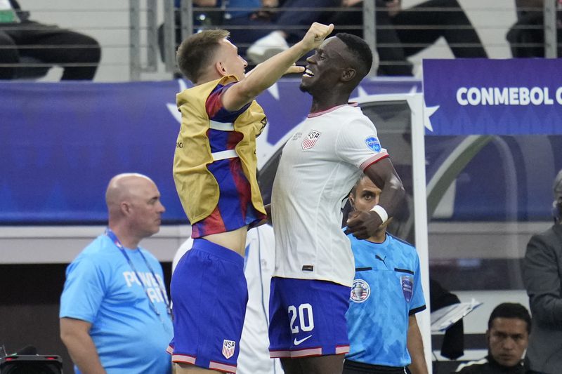 Folarin Balogun of the United States, right, celebrates with teammate Kristoffer Lund after scoring his side's 2nd goal against Bolivia during a Copa America Group C soccer match in Arlington, Texas, Sunday, June 23, 2024. (AP Photo/Julio Cortez)