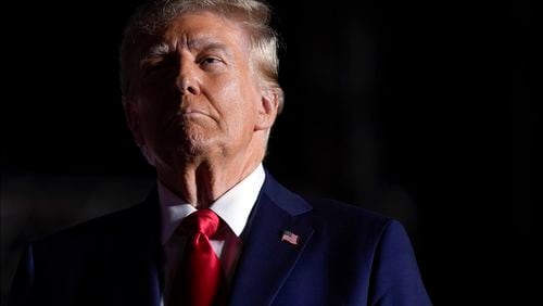 Republican presidential nominee former President Donald Trump listens to opera singer Christopher Macchio after speaking at a campaign rally at the Butler Farm Show, Saturday, Oct. 5, 2024, in Butler, Pa. (AP Photo/Evan Vucci)