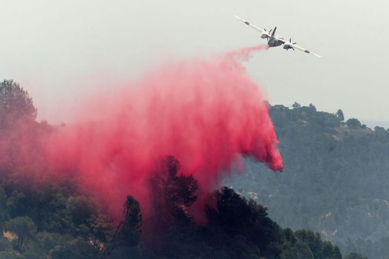 An air tanker drops retardant while trying to stop the Aero Fire from spreading in the Copperopolis community of Calaveras County, Calif., on Tuesday, June 18, 2024. (AP Photo/Noah Berger)