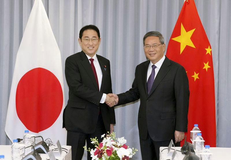 Japanese Prime Minister Fumio Kishida, left, shakes hands with Chinese Premier Li Qiang before their meeting in Seoul, South Korea, Sunday, May 26, 2024. (Daisuke Suzuki/Kyodo News via AP)