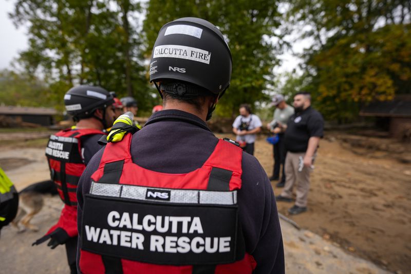 Search and Rescue members take a briefing in the aftermath of Hurricane Helene, Tuesday, Oct. 1, 2024, in Swannanoa, N.C. (AP Photo/Mike Stewart)