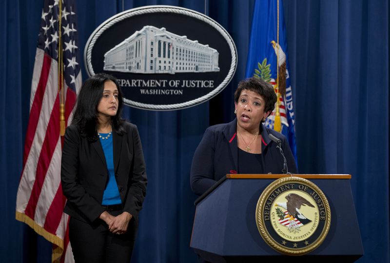 FILE - Attorney General Loretta Lynch, joined by Principal Deputy Assistant Attorney General Vanita Gupta speaks during a news conference at the Justice Department in Washington, Wednesday, Feb. 10, 2016, about Ferguson, Mo. The federal government sued Ferguson on Wednesday, one day after the city council voted to revise an agreement aimed at improving the way police and courts treat poor people and minorities in the St. Louis suburb. (AP Photo/Carolyn Kaster, File)