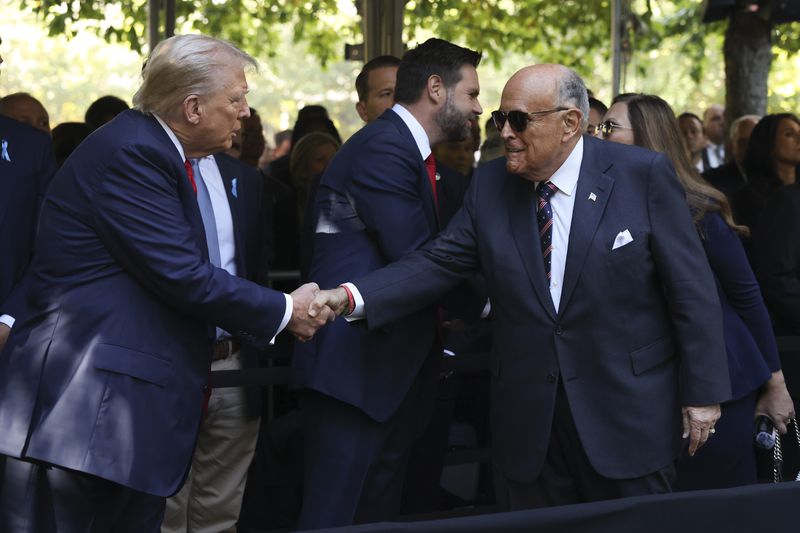 Republican presidential nominee former President Donald Trump greets Rudy Giuliani while attending the 9/11 Memorial ceremony on the 23rd anniversary of the Sept. 11, 2001 terror attacks, Wednesday, Sept. 11, 2024, in New York. (AP Photo/Yuki Iwamura)