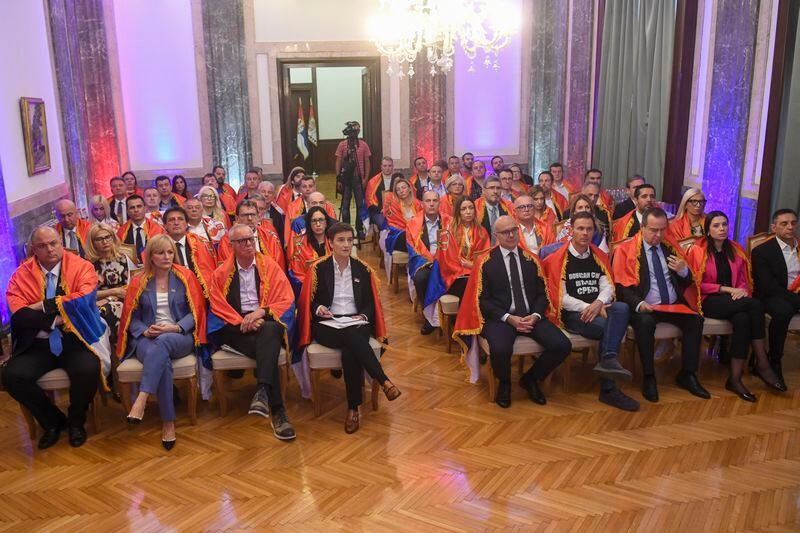 In this photo provided by the Serbian Presidential Press Service, Members of Serbia's government wrapped in Serbian flags as they watch the vote in the U.N.that established an annual commemoration of the 1995 genocide of Bosnia's Muslims by the Bosnian Serbs in Belgrade, Serbia, Thursday, May 23, 2024. (Serbian Presidential Press Service via AP)