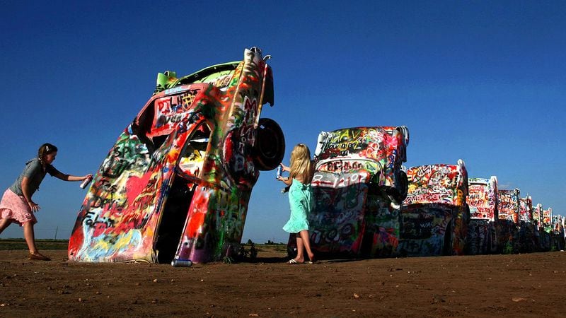 It’s OK to add one’s own artistic mark at the famed Cadillac Ranch. Michael S. Williamson/Washington Post