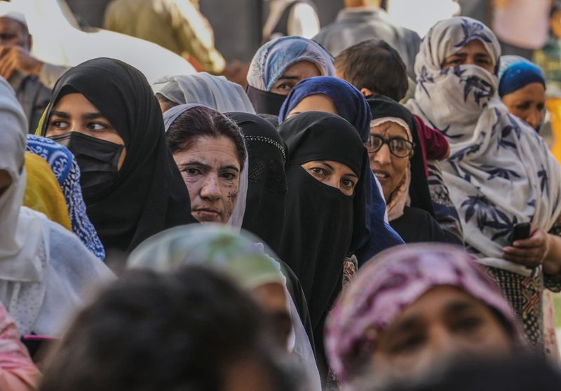 Kashmiri women queue up at a polling booth to cast their vote during the final phase of an election to choose a local government in Indian-controlled Kashmir, north of Srinagar, Tuesday, Oct.1, 2024. (AP Photo/Mukhtar Khan)