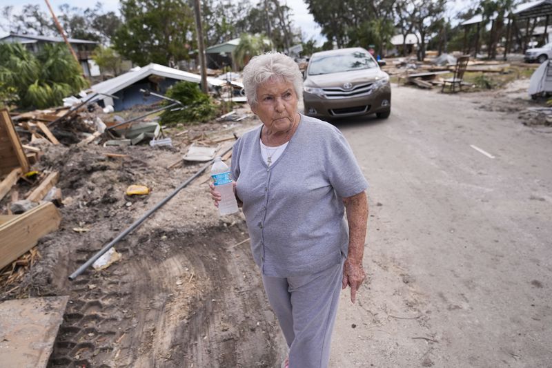 Elsie Hicks looks at the destruction of the home she has loved in for 25 years, in the aftermath of Hurricane Helene, in Horseshoe Beach, Fla., Saturday, Sept. 28, 2024. (AP Photo/Gerald Herbert)