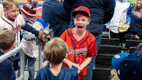 Jack Plageman, 9, of Brookhaven reacts after grabbing a ball at the Braves home opening day game versus the Diamondbacks at Truist Park in Atlanta on Friday, April 5, 2024. (Arvin Temkar / arvin.temkar@ajc.com)