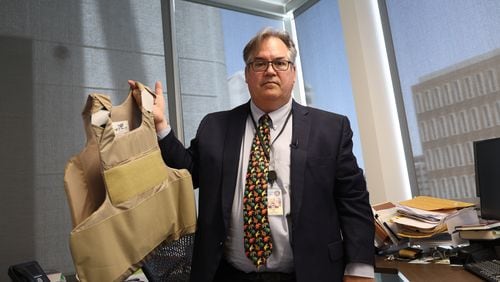 Tom Liddy, a lifelong Republican who heads the civil division at the Maricopa County Attorney’s Office, shows the bulletproof vest the FBI told him to wear after he and his family were threatened. (Photo by Denzen Cortez/News21)