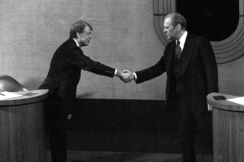 FILE - Jimmy Carter, left, and Gerald Ford, right, shake hands before the third presidential debate, Oct. 22, 1976, in Williamsburg, Va. (AP Photo/File)