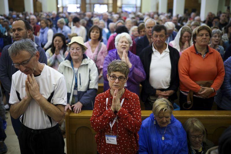 Pilgrims say their prayers inside the St. James Church in Medjugorje, Bosnia, Thursday, Sept. 19, 2024. (AP Photo/Armin Durgut)