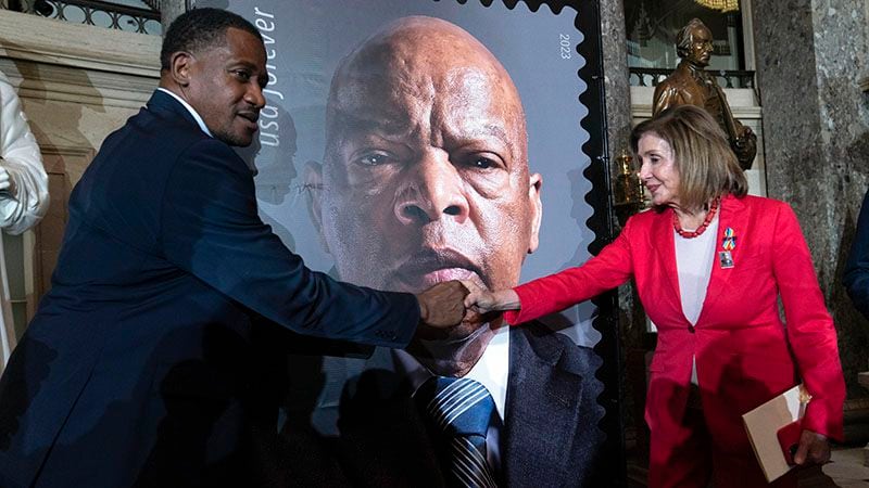 Rep. Nancy Pelosi D-Calif., shake hands with Michael Collins during the stamp unveiling ceremony for Rep. John Lewis on Capitol Hill, Wednesday, June 21, 2023, in Washington. (AP Photo/Jose Luis Magana)