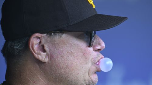 San Diego Padres manager Mike Shildt blows a bubble during the first inning inning of a baseball game against the Washington Nationals, Thursday, July 25, 2024, in Washington. (AP Photo/John McDonnell)