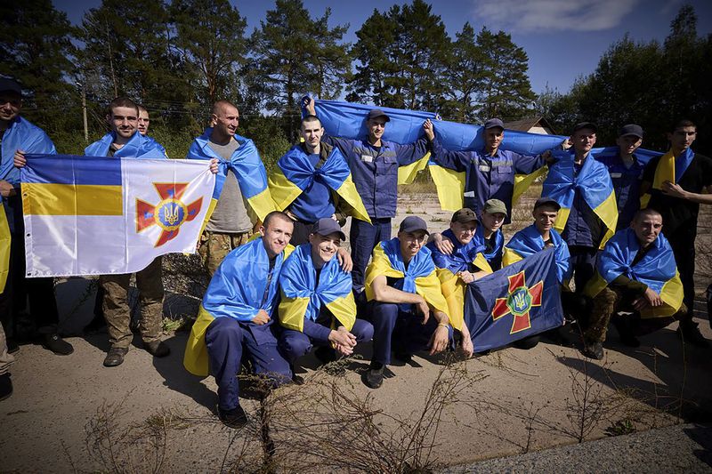 Ukrainians pose for a photo after being released in a prisoner exchange at an undisclosed location in Ukraine, Saturday Sept. 14, 2024. (Ukrainian Presidential Press Office via AP)