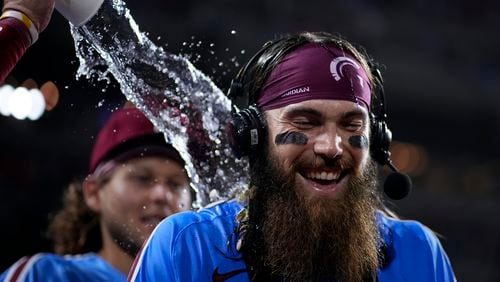 Philadelphia Phillies' Brandon Marsh is doused by Bryson Stott after the Phillies won a baseball game against the Los Angeles Dodgers, Thursday, July 11, 2024, in Philadelphia. (AP Photo/Matt Slocum)