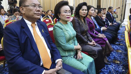 In this photo released by Agence Kampuchea Press (AKP), Cambodian tycoons, Ly Yong Phat, left, attends the welcome the return of cultural treasures of artifact statues ceremony in Peace Palace in Phnom Penh, Cambodia, Thursday, Aug. 22. 2024. (AKP via AP)