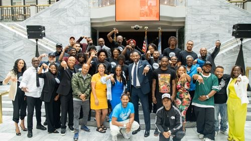 The graduates of the Rico Wade Music Executive Training Program gather for a group photo in City Hall with top music executives and guest speakers of the program on July 29, 2024.