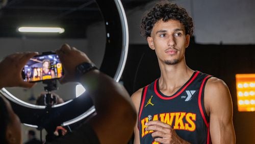 Waiting for the camera to be set, Hawks’ player Zaccharie Risacher #10, gets ready to be interviewed during media day on Monday, Sept 30, 2024 where media outlets including the Associated Press, Getty, NBA and many others gather to take photos, conduct interviews and gather footage.  (Jenni Girtman for The Atlanta Journal-Constitution)