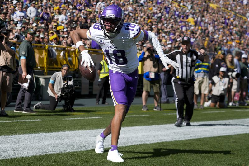 Minnesota Vikings wide receiver Justin Jefferson (18) celebrates a touchdown during the first half of an NFL football game against the Green Bay Packers, Sunday, Sept. 29, 2024, in Green Bay, Wis. (AP Photo/Morry Gash)