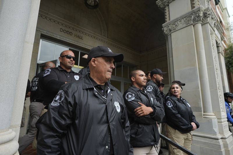 University security officers block pro-Palestinian demonstrators from Dodd Hall on the campus of UCLA in Los Angeles, Thursday, May 23, 2024. (AP Photo/Damian Dovarganes)