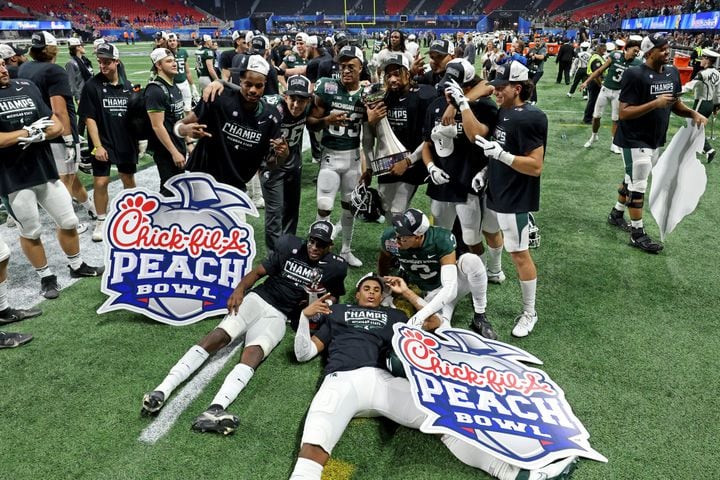 Michigan State Spartans players celebrate their 31-21 win against the Pittsburgh Panthers during the Chick-fil-A Peach Bowl at Mercedes-Benz Stadium in Atlanta, Thursday, December 30, 2021. JASON GETZ FOR THE ATLANTA JOURNAL-CONSTITUTION