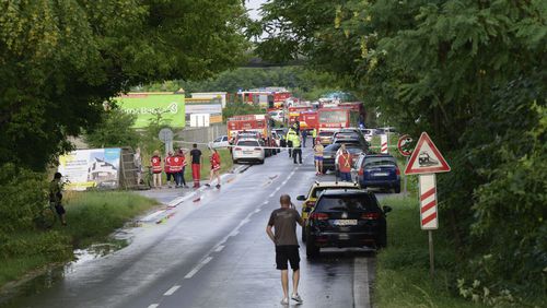 Firefighters vehicles and emergency vehicles on the site of the collision of a bus with a train near the town of Nove Zamky, Slovakia, Thursday, June 27, 2024. Officials in Slovakia says that a train traveling from the Czech capital of Prague to the Hungarian capital of Budapest collided with a bus in southern Slovakia, leaving at least five people dead and five injured. Police and railway officials say that more than 100 people were aboard the Eurocity train when the accident took place shortly after 5 p.m. (1500 GMT) in the town of Nove Zamky. (Henrich Misovic/TASR via AP)