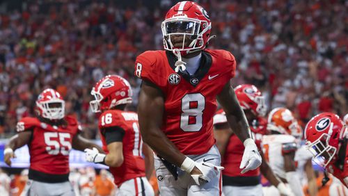 Georgia wide receiver Colbie Young (8) celebrates a touchdown by teammate Nate Frazier (not pictured) during the second half against Clemson at Mercedes-Benz Stadium, on Saturday, Aug. 31, 2024, in Atlanta. Georgia won 34-3. (Jason Getz/AJC)