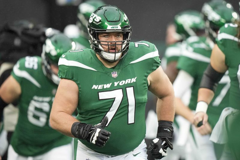 FILE- New York Jets offensive guard Wes Schweitzer (71) warms up before an NFL football game against the Atlanta Falcons on Sunday, Dec. 3, 2023, in East Rutherford, N.J. (AP Photo/Bryan Woolston, File)