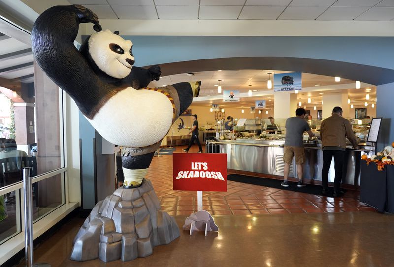 A statue of the DreamWorks Animation character Po, from the "Kung Fu Panda" films, stands near employees inside the DreamWorks commissary, Wednesday, Sept. 25, 2024, in Glendale, Calif. (AP Photo/Chris Pizzello)