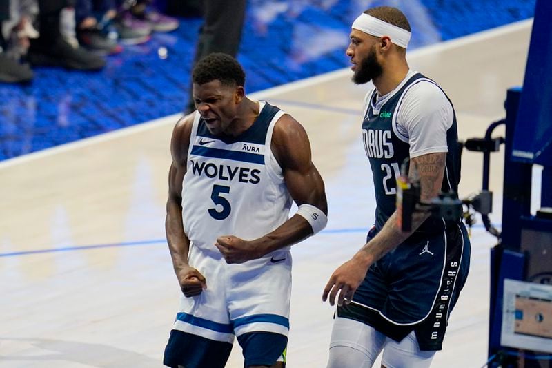 Minnesota Timberwolves guard Anthony Edwards (5) celebrates after scoring against Dallas Mavericks center Daniel Gafford (21) during the second half in Game 3 of the NBA basketball Western Conference finals, Sunday, May 26, 2024, in Dallas. (AP Photo/Gareth Patterson)