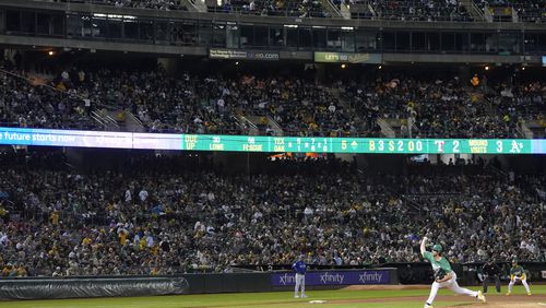 Oakland Athletics pitcher Joe Boyle, bottom, works against the Texas Rangers during the fifth inning of a baseball game in Oakland, Calif., Wednesday, Sept. 25, 2024. (AP Photo/Jeff Chiu)