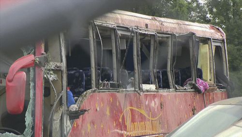 A damaged bus is shown after several people were killed and dozens injured after the commercial bus overturned on Interstate 20 early Saturday, Aug. 31 2024 in Warren County, Miss., according to the Mississippi Highway Patrol. (WAPT via AP)