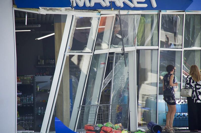 In this photo released by the Dnipro Regional Administration, people stand near shop windows damaged following Russia's missile attack in Dnipro, Ukraine, Wednesday, July 3, 2024. (Dnipro Regional Administration via AP)