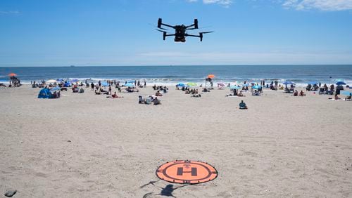 A drone lands for a battery swap at Rockaway Beach in New York, Thursday, July 11, 2024. A fleet of drones patrolling New York City’s beaches for signs of sharks and struggling swimmers is drawing backlash from an aggressive group of seaside residents: local shorebirds. Since the drones began flying in May, flocks of birds have repeatedly swarmed the devices, forcing the police department and other city agencies to adjust their flight plans. (AP Photo/Seth Wenig)