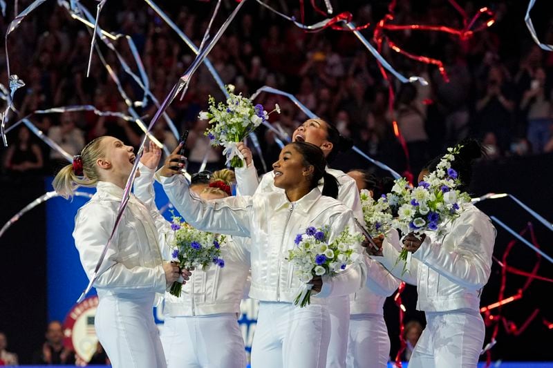 The women celebrate as the 2024 team is named for the Paris Olympics at the United States Gymnastics Olympic Trials on Sunday, June 30, 2024, in Minneapolis. (AP Photo/Abbie Parr)