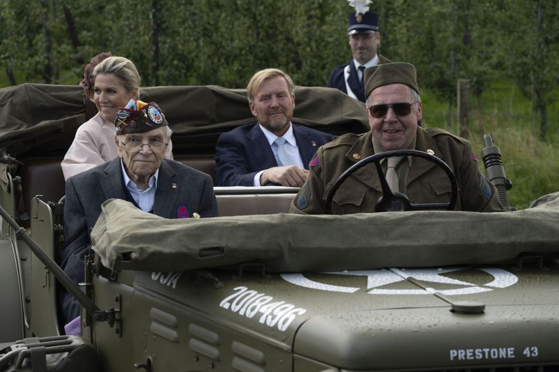 World War II veteran Kenneth Thayer, Dutch King Willem-Alexander and Queen Maxima drive in a jeep during a ceremony marking the 80th anniversary of the liberation of the south of the Netherlands in Mesch, Thursday, Sept. 12, 2024. (AP Photo/Peter Dejong, Pool)