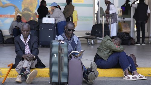 Stranded passengers wait for their delayed flights out of JKIA airport after flights were grounded following workers’ protesting a planned deal between the government and a foreign investor, in Nairobi, Kenya, Wednesday, Sept. 11, 2024. (AP Photo/Brian Inganga)