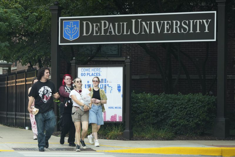 Students walk past the DePaul University in Chicago, Wednesday, Aug. 28, 2024. (AP Photo/Nam Y. Huh)