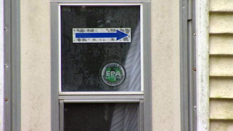A sign on a window in a home in Ocala, Florida, points potential drug customers in the right direction to use a drive-thru window to buy illegal drugs like heroin, police said.