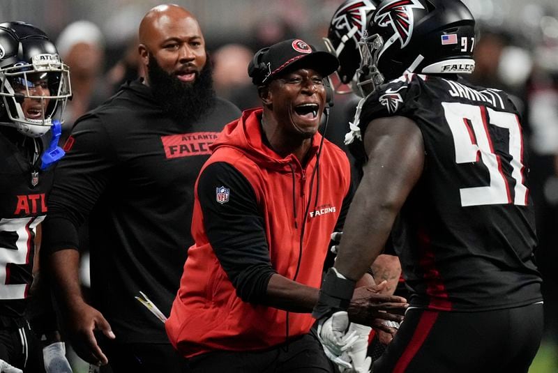 Atlanta Falcons head coach Raheem Morris congratulates Atlanta Falcons defensive end Grady Jarrett (97) after a sack during the second half of an NFL football game against the Pittsburgh Steelers on Sunday, Sept. 8, 2024, in Atlanta. (AP Photo/John Bazemore)