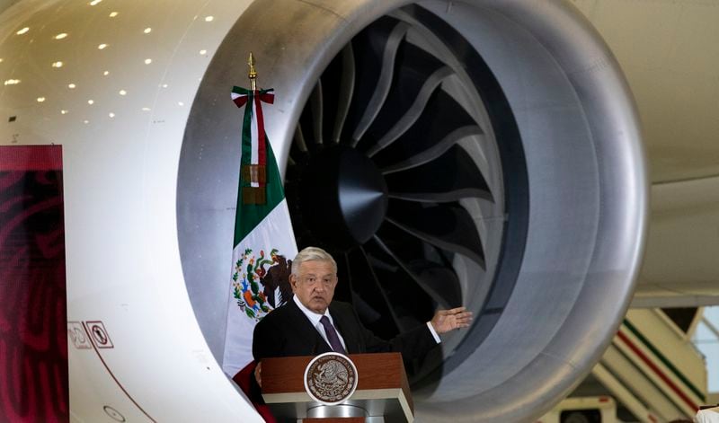 FILE - Mexican President Andres Manuel Lopez Obrador gives his daily, morning press conference in front of the former presidential plane at Benito Juarez International Airport in Mexico City, July 27, 2020. (AP Photo/Marco Ugarte, File)