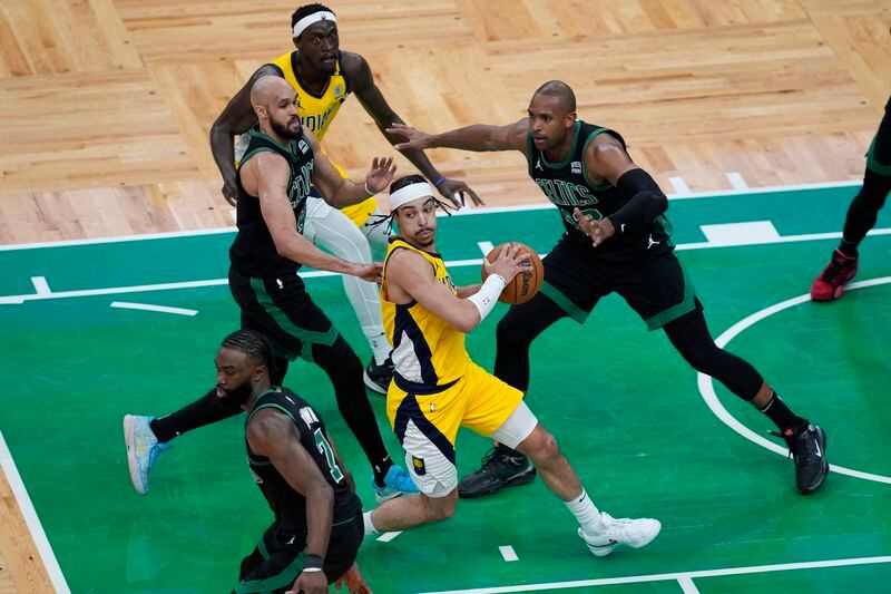 Indiana Pacers guard Andrew Nembhard (2) center looks to pass during the first half of Game 2 of the NBA Eastern Conference basketball finals against the Boston Celtics, Thursday, May 23, 2024, in Boston. (AP Photo/Michael Dwyer)