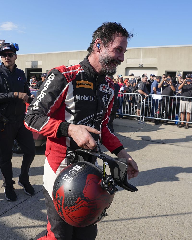 Keanu Reeves walks in the garage area following a GR Cup Series auto race at Indianapolis Motor Speedway, Saturday, Oct. 5, 2024, in Indianapolis. (AP Photo/Darron Cummings)