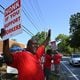 Striking AT&T workers hold signs outside AT&T facility on Brockett Road, Friday, Aug. 30, 2024, in Tucker. Some 17,000 AT&T workers in Atlanta and across the Southeast are on strike, having walked off their jobs on Aug. 16 amid an impasse in contract negotiations. (Hyosub Shin / AJC)