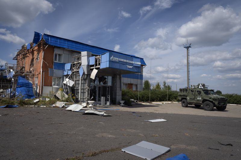 A Ukrainian Army Armored Personnel Carrier passes drives past a gas metering station of Russian energy giant Gazprom in Sudzha, Kursk region, Russia, Friday, Aug. 16, 2024. This image was approved by the Ukrainian Defense Ministry before publication. (AP Photo)