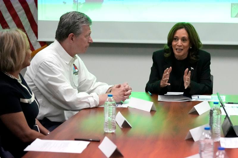 Democratic presidential nominee Vice President Kamala Harris, right, receives a briefing from North Carolina Gov. Roy Cooper on the damage from Hurricane Helene, Saturday, October 5, 2024 in Charlotte, N.C. (AP Photo/Chris Carlson)