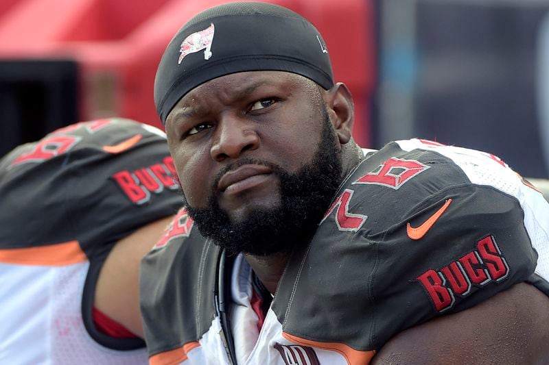 FILE — Tampa Bay Buccaneers tackle Gosder Cherilus watches Oct. 4, 2015, from the bench during an NFL football game against the Carolina Panthers, in Tampa, Fla. (AP Photo/Phelan M. Ebenhack, File)