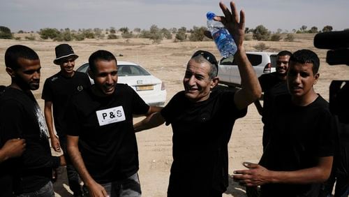 Qaid Farhan Alkadi, 52, who was held hostage by Hamas militants in Gaza Strip, meets his relatives and friends after arriving in the Khirbet Karkur village, near Rahat, southern Israel, Wednesday, Aug. 28, 2024. (AP Photo/Mahmoud Illean)